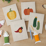The four finished Peppers and Zucchini mini canvases laid out on a table