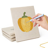 Hand punching one of the Peppers and Zucchini mini canvases