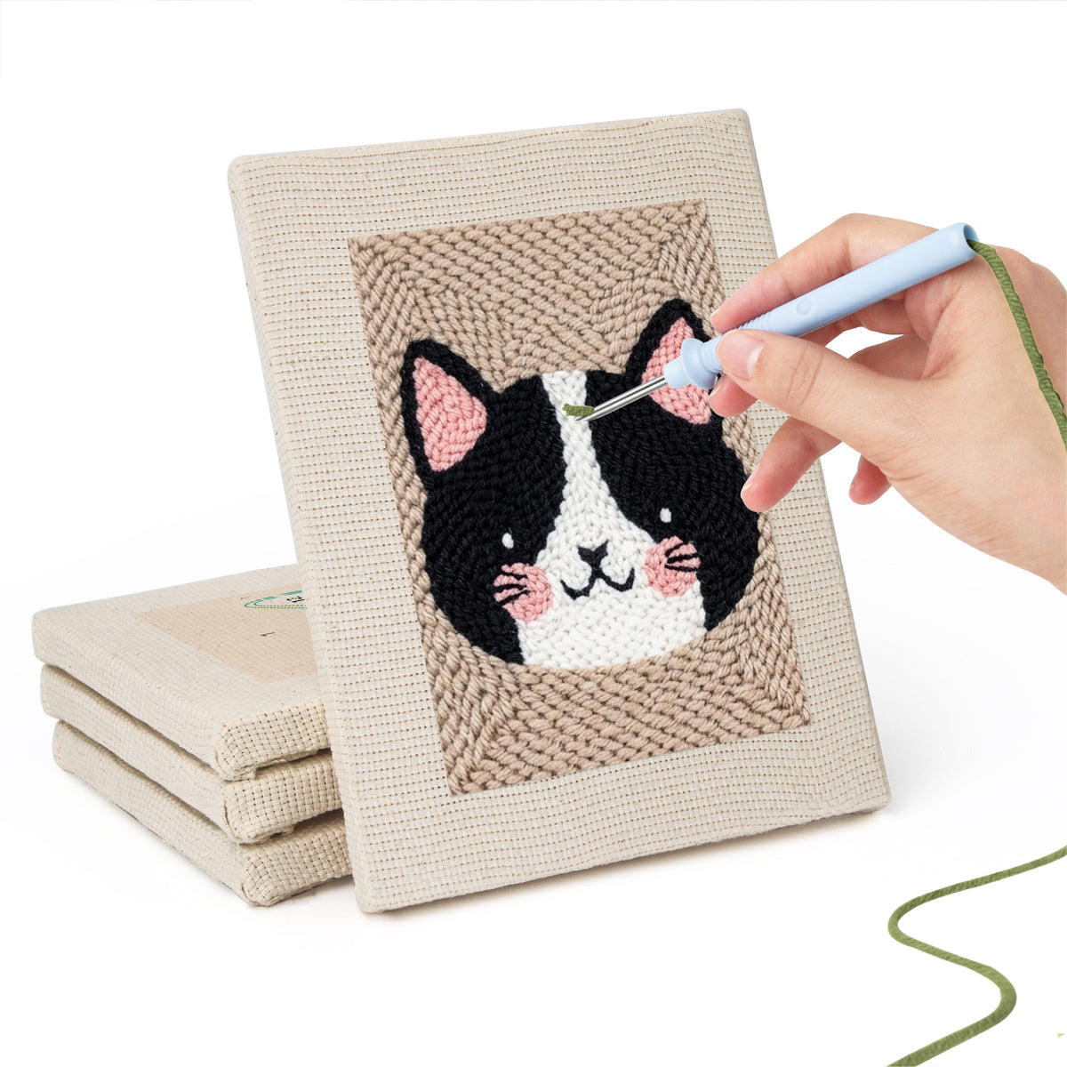 Hand punching one of the Pet Portraits mini canvases
