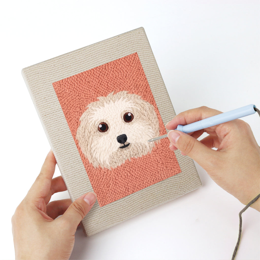 Punching a Pet Portraits mini canvas with the punch needle
