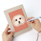 Punching a Pet Portraits mini canvas with the punch needle