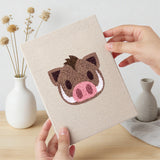 Hand holding a finished Pig and Camel mini canvas