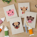 The four finished Pig and Camel mini canvases laid out on a table