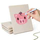 Hand punching one of the Pig and Camel mini canvases