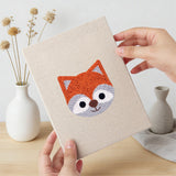 Hand holding a finished Piglet and Fox mini canvas