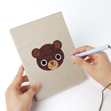Punching a Piglet and Fox mini canvas with the punch needle