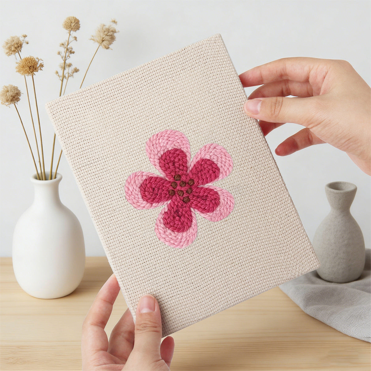 Hand holding a finished Pink Blossom Heads mini canvas