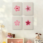 The four Pink Blossom Heads mini canvases on a wall above a shelf
