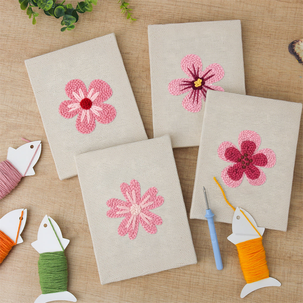 The four finished Pink Blossom Heads mini canvases laid out on a table