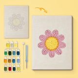 Pink Daisy Head canvas before and after punching, with the threads and tools