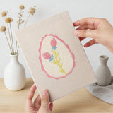 Hand holding a finished Pink Egg Posies mini canvas