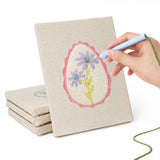 Hand punching one of the Pink Egg Posies mini canvases