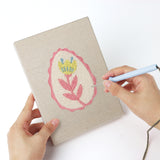 Punching a Pink Egg Posies mini canvas with the punch needle