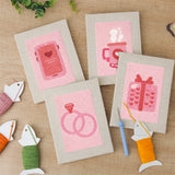 The four finished Pink Love Tokens mini canvases laid out on a table