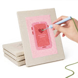 Hand punching one of the Pink Love Tokens mini canvases