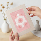 Hand holding a finished Pink Pastel Eggs mini canvas