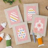 The four finished Pink Pastel Eggs mini canvases laid out on a table