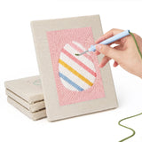 Hand punching one of the Pink Pastel Eggs mini canvases