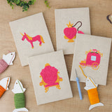 The four finished Pink Princess Day mini canvases laid out on a table