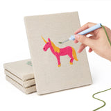 Hand punching one of the Pink Princess Day mini canvases