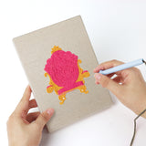 Punching a Pink Princess Day mini canvas with the punch needle