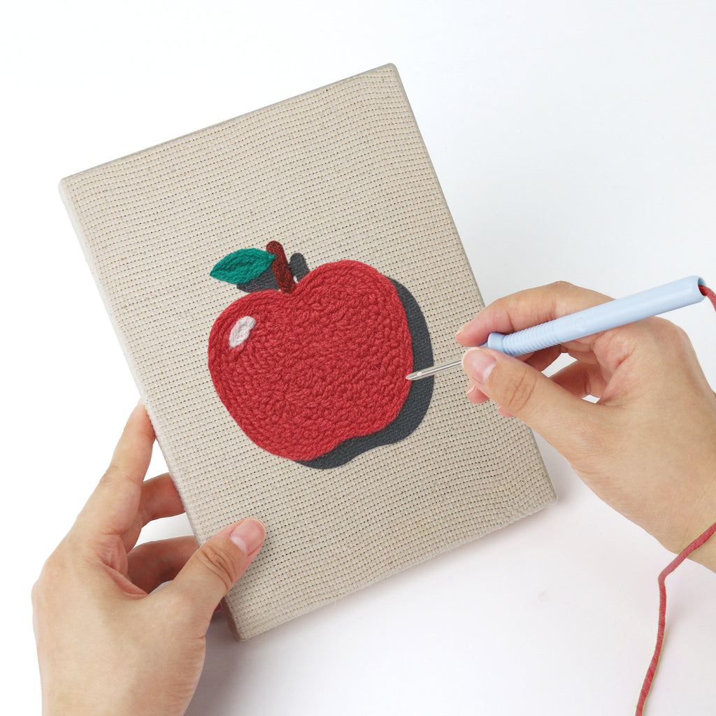 Punching a Pink School Backpack mini canvas with the punch needle