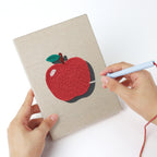 Punching a Pink School Backpack mini canvas with the punch needle