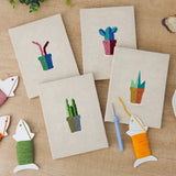 The four finished Pink Stem Cacti mini canvases laid out on a table