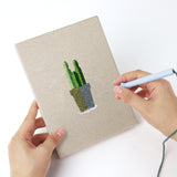 Punching a Pink Stem Cacti mini canvas with the punch needle