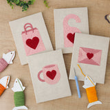 The four finished Pink Valentine Hearts mini canvases laid out on a table
