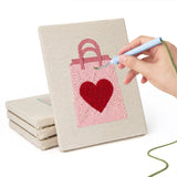 Hand punching one of the Pink Valentine Hearts mini canvases
