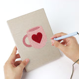 Punching a Pink Valentine Hearts mini canvas with the punch needle