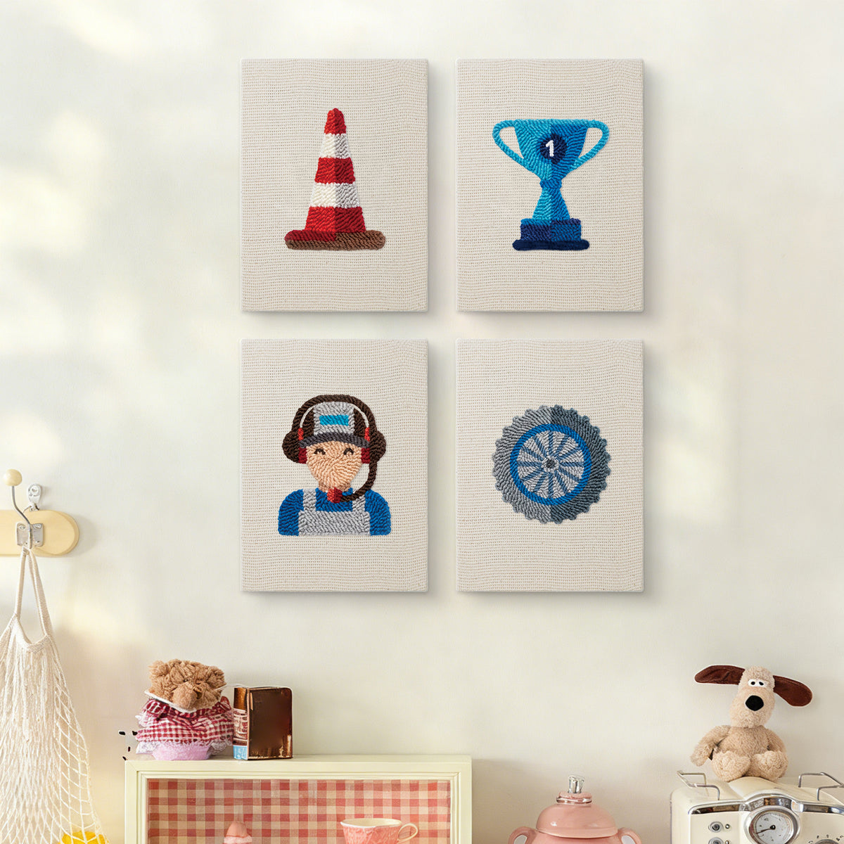 The four Pit Crew Trophy mini canvases on a wall above a shelf