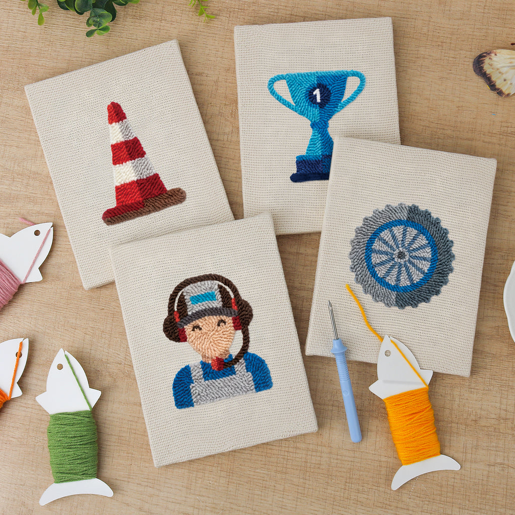 The four finished Pit Crew Trophy mini canvases laid out on a table