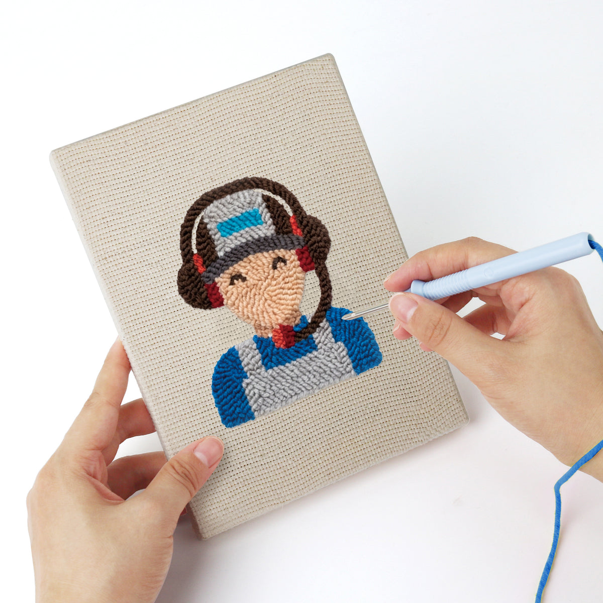 Punching a Pit Crew Trophy mini canvas with the punch needle
