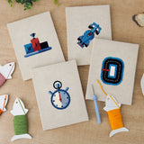 The four finished Podium Race Car mini canvases laid out on a table