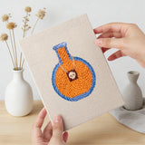 Hand holding a finished Potion and Cupcake mini canvas