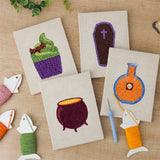 The four finished Potion and Cupcake mini canvases laid out on a table