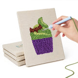 Hand punching one of the Potion and Cupcake mini canvases