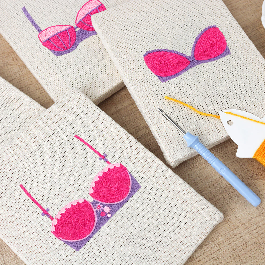 The four Pretty Pink Bras mini canvases on a wall above a shelf