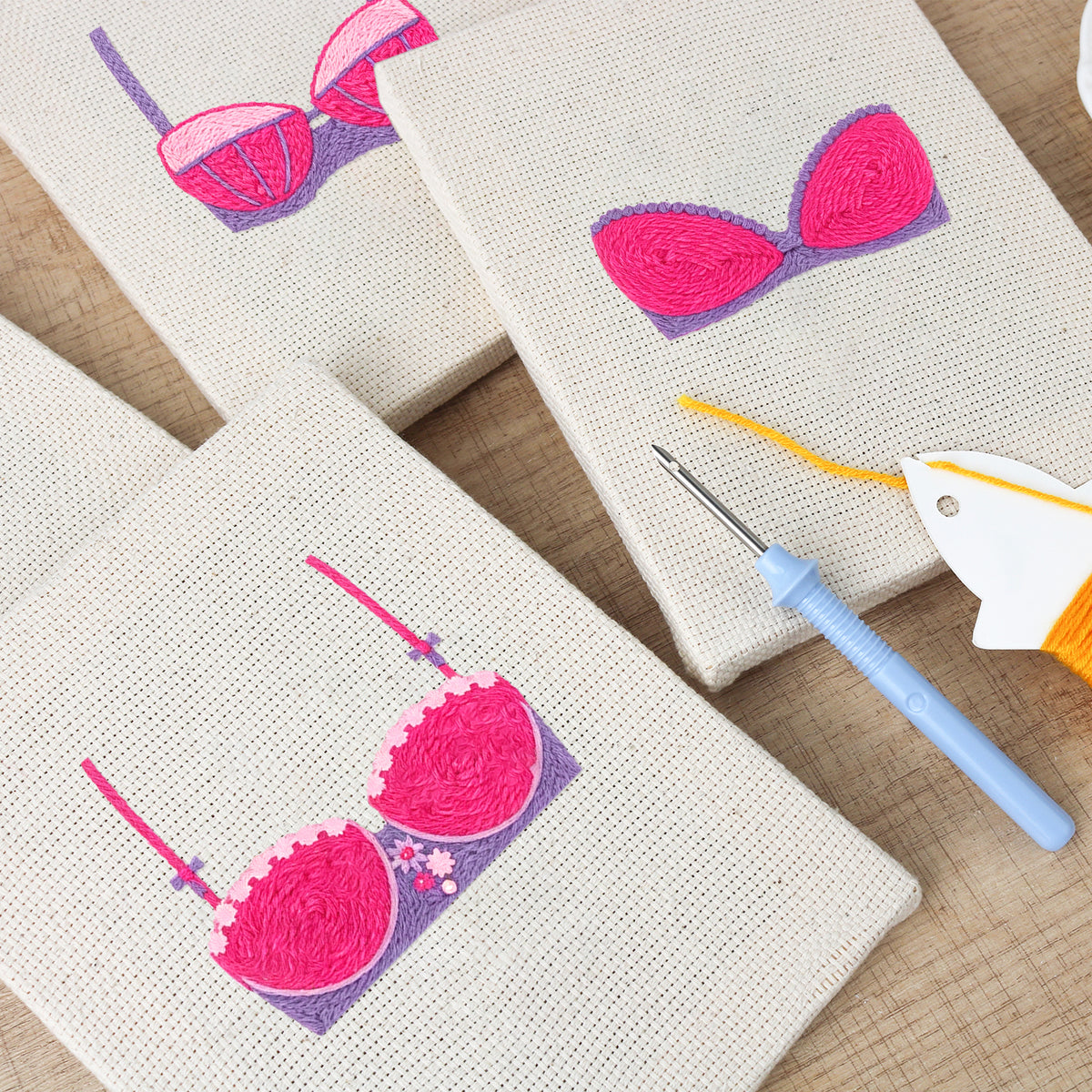 The four Pretty Pink Bras mini canvases on a wall above a shelf