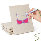 Hand punching one of the Pretty Pink Bras mini canvases