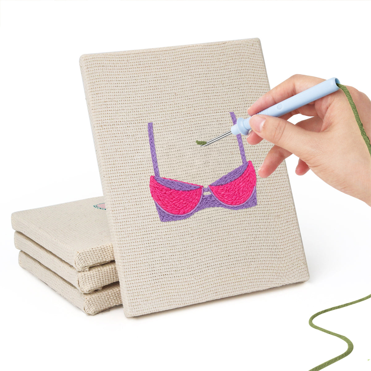Hand punching one of the Pretty Pink Bras mini canvases