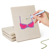 Hand punching one of the Pretty Pink Bras mini canvases