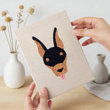Hand holding a finished Pug and Doberman mini canvas