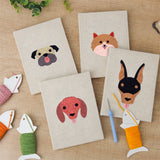 The four finished Pug and Doberman mini canvases laid out on a table