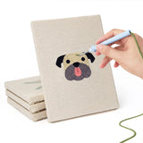 Hand punching one of the Pug and Doberman mini canvases
