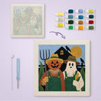 Pumpkin Farm Couple canvas before and after punching, with the threads and tools