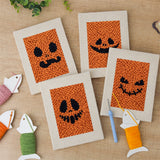 The four finished Pumpkin Grins mini canvases laid out on a table
