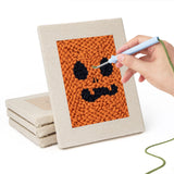 Hand punching one of the Pumpkin Grins mini canvases